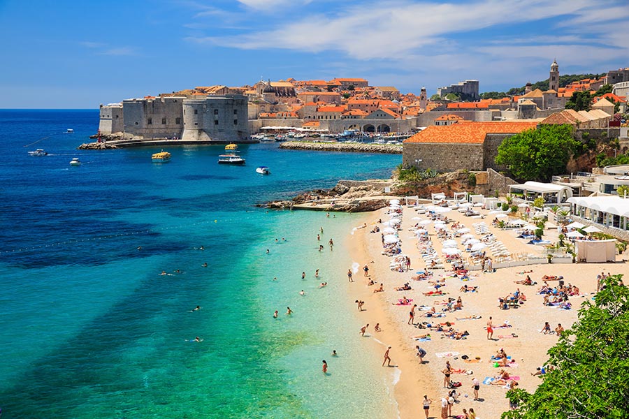 Red-roofed old town of Dubrovnik perched above the Adriatic Sea on a clear day