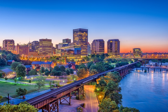 Richmond, Virginia skyline at dusk, seen across the James River near the state's historic colonial sites.
